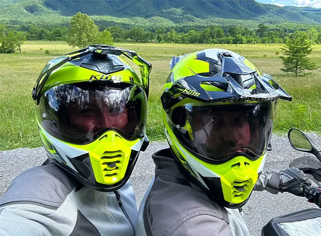 Sam and a friend in adventure motorcycle helmets