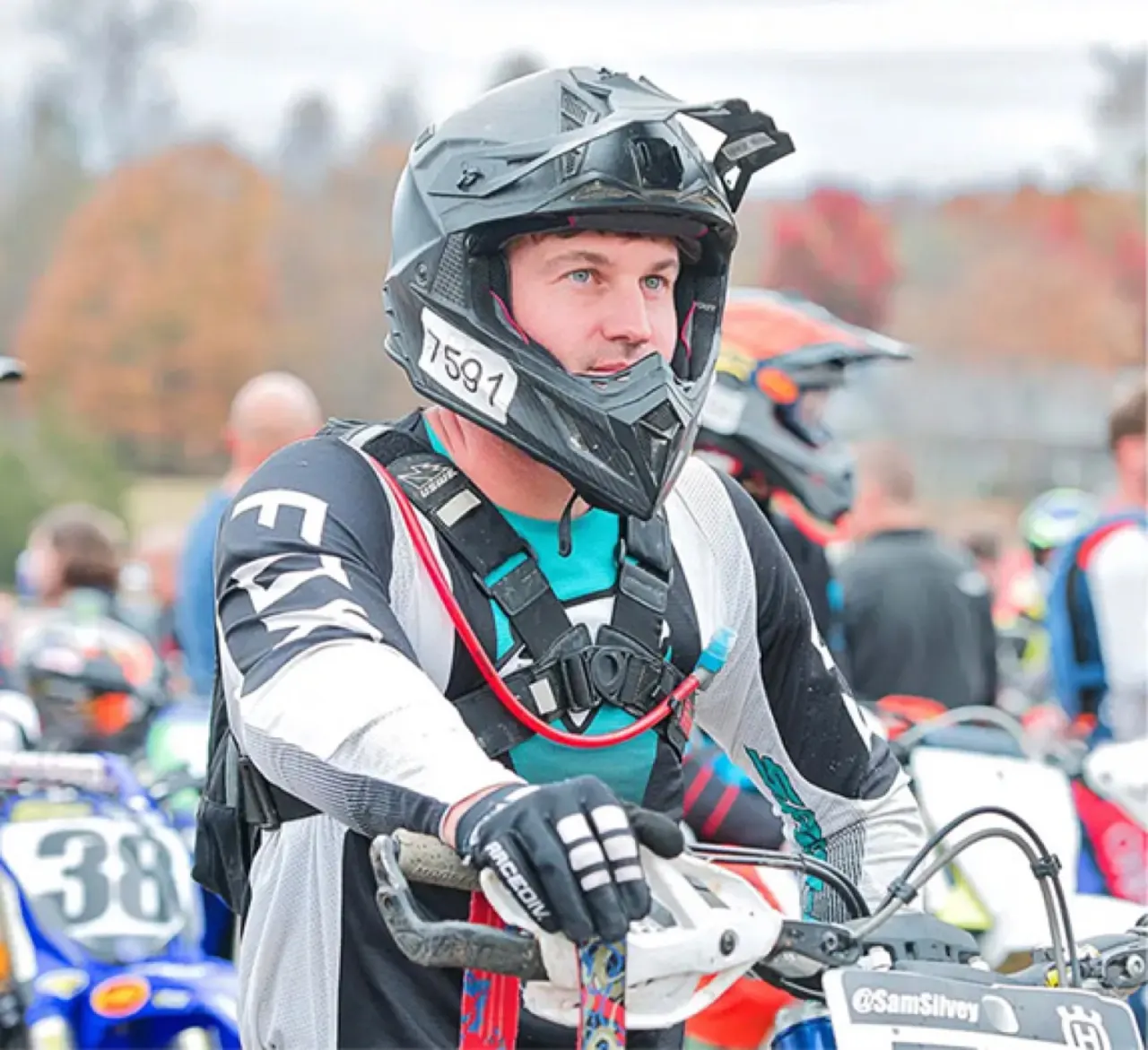 Sam in race gear on his dirt bike in the paddock